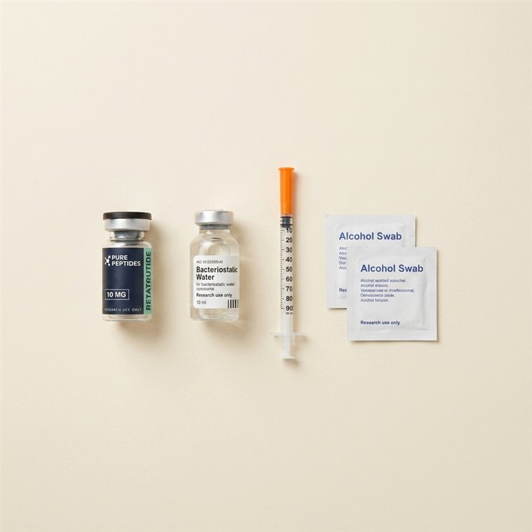 Vial, bacteriostatic water, insulin syringe and alcohol swabs laid out